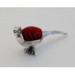 A .925 silver novelty pin cushion formed as a pheasant with red velvet cushion to back. Approx 2"