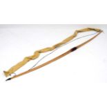 Archery:  long bow of laminated construction marked ' 50lbs @ 28 ins ' with leather stitched