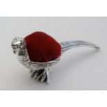 A .925 silver novelty pin cushion formed as a pheasant with red velvet cushion to back. Approx 2"