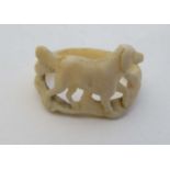 A Victorian carved scarf ring with dog decoration . Approx 1" wide  CONDITION: Please Note -  we