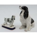 Dogs: Two ceramic models of dogs formed as black and white Springer Spaniels. A Lomonsov seated