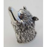 A novelty silver vesta case formed as the head of a stylised fox with red glass eyes, and hinged lid