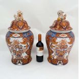 A pair of large lidded Chinese baluster vases . Hand painted with images of birds and floral and