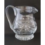 A large cut glass jug with loop handle 9" high  CONDITION: Please Note -  we do not make reference