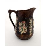 A 19thC Bargeware / Measham jug , decorated in traditional manner with applied floral sprays with