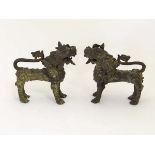 A pair of bronze Vyala, Nepal , 19th / 20th century, Their fanged mouths open, the bodies with swirl