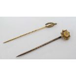 2 9ct gold and gilt metal stick pins, one set with a diamond, the other surmounted by a wishbone set