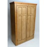 A 19thC stripped and waxed pine wardrobe with 2 doors opening to reveal hanging section with hat