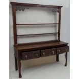 An 18thC and later oak 3-drawer dresser with open plate rack with pine lined drawers ( front to back