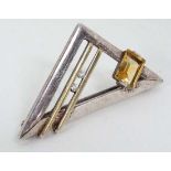 A .925 silver brooch of abstract design set with yellow and white stones 1 3/4" wide  CONDITION: