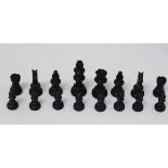 A set of boxwood and stained boxwood small chess pieces, housed in a wooden 2 sectional box with red