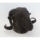 An old bronze Ram's head having coiled horns, with wall hanging provision. 7" high  CONDITION: