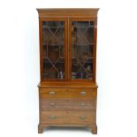 A Georgian bookcase chest having a satinwood cross banding boxwood and ebony stringing and pair of