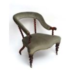 A charming Victorian upholstered serpentine fronted open arm chair with barley twist supports and