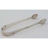 Geo III silver sugar tongs with bright cut decoration. Hallmarked London 1805 maker Peter &