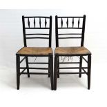 Arts & Crafts : A pair of Morris & Co Ebonised Sussex chairs with envelope rush seats and turned