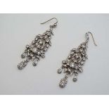 A pair of white metal drop earrings set with a profusion of paste stones.  CONDITION: Please Note -