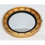 An early 0thC gilt shaped convex gunshot mirror 16 1/2" diameter.  CONDITION: Please Note -  we do