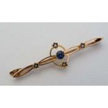 A 15ct gold bar brooch set with central sapphire and 4 seed pearls. 2" wide CONDITION: Please Note -