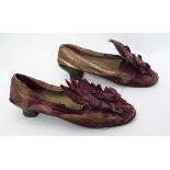 A pair of ladies silk shoes c1860, with rosette detail to front, leather covered heels and leather