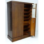 Compactum 43 Regent Street London : A fine oak wardrobe with labelled glass fronted sections,