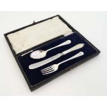 A cased Christening set comprising knife , fork and spoon hallmarked Sheffield 1920 maker James