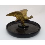 A gilt bronze image of a condor mounted upon a circular onyx dish formed base. 11" diameter