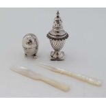 A silver plate egg formed pepperette together with another of pedestal urn form and a mother of