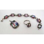 A suite of white metal jewellery set with Mystic Topaz comprising bracelet ring and pendant