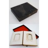 A Victorian photograph album covered in red silk with gilt page edges. The silk decorated with