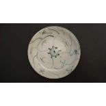 A small Chinese blue and white ceramic plate. Loosely decorated in an Oriental style. 5''