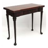 A Geo II mahogany fold over shaped card table with frieze drawer, shaped knees, turned legs and