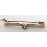 A 9ct gold bar brooch / tie pin set with central diamond (diamond approx 0.20ct)  CONDITION: