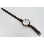 WW1 Watch  : a nickel cased circular mechanical wristwatch , with enamel dial, red 12, Arabic Hour