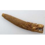 A carved bone knife handle in the form of a Chinese open mouthed dragon. 3 7/8" long 

 CONDITION: