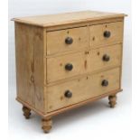 A small proportion Victorian stripped pine chest of drawers having 2 short over 3 long drawers on