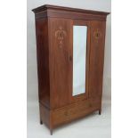 An Edwardian inlaid and strung mahogany double wardrobe with central bevelled edge mirror to door