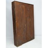 A 19thC stained pine shallow house keepers cupboard / coat cupboard with hat shelf and two pegs ,