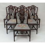 A Set 6 (4+2) Hepplewhite style early 20thC mahogany dining chairs with needlework covered drop in