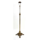 An early 20thC brass standard lamp of telescopic form with Corinthian column top, reeded column