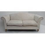 Laura Ashley c: A pair of damask silk cream upholstered large 2-seat sofas with scroll arms and hump