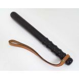 A 20thC turned hardwood Police Officer's truncheon , with waved grip section and leather lanyard .