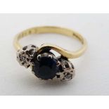 An 18ct gold ring  with central sapphire flanked by 2 diamonds  CONDITION: Please Note -  we do