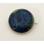 Ruskin Pottery: A white metal brooch set with Ruskin pottery cabochon . Marked Ruskin England to