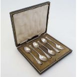 A set of 6 silver teaspoons with engraved decoration  A boxed set of six engraved coffee spoons by