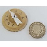 A vegetable ivory and mother of pearl wist marker. With engraved numbers.  1 1/2'' diameter.