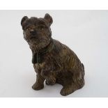 A hand painted cast bronze figure of a sejant terrier dog with tasseled collar and hinged head 3 1/