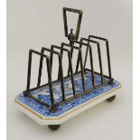 A silver plated and blue and white transfer printed ceramic toast rack having 6 divisions standing