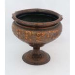 Arts and Crafts : a pedestal copper jardiniere   With embossed leaf and foliate decoration  with