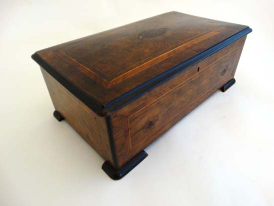 A Victorian inlaid walnut music box case with strung and cross banded decoration 19 1/2 wide.